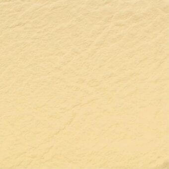 Pale yellow stucco texture with granular surface and mottled tone, displaying subtle variations in light and shadow across an even composition.
